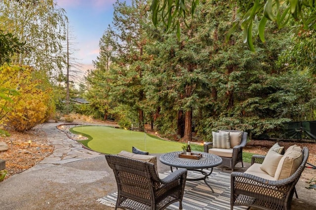 patio terrace at dusk featuring an outdoor hangout area