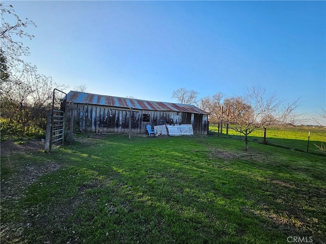 view of yard with a rural view and an outdoor structure