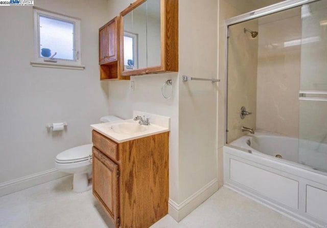 full bathroom featuring toilet, enclosed tub / shower combo, and vanity