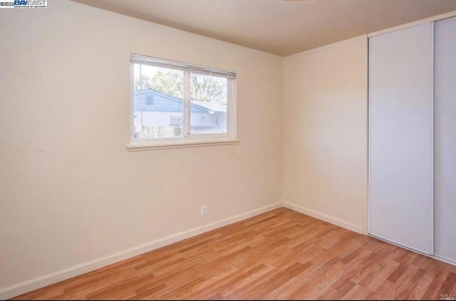 unfurnished room with light hardwood / wood-style floors