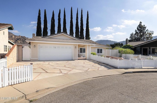 view of front facade with a garage and a mountain view