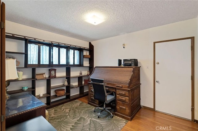 office featuring a textured ceiling and hardwood / wood-style flooring