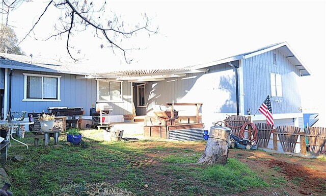 back of property featuring a pergola