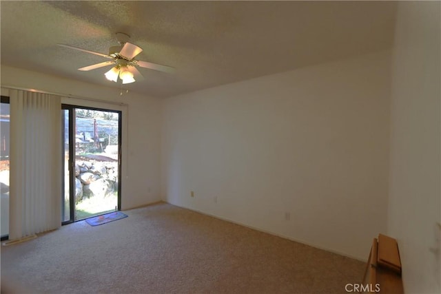 spare room with ceiling fan, carpet floors, and a textured ceiling