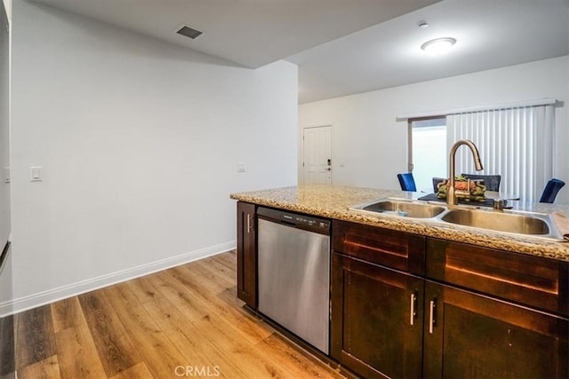 kitchen featuring dark brown cabinetry, sink, light wood-type flooring, light stone counters, and stainless steel dishwasher