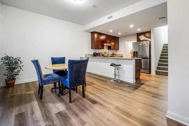 dining area with light wood-type flooring