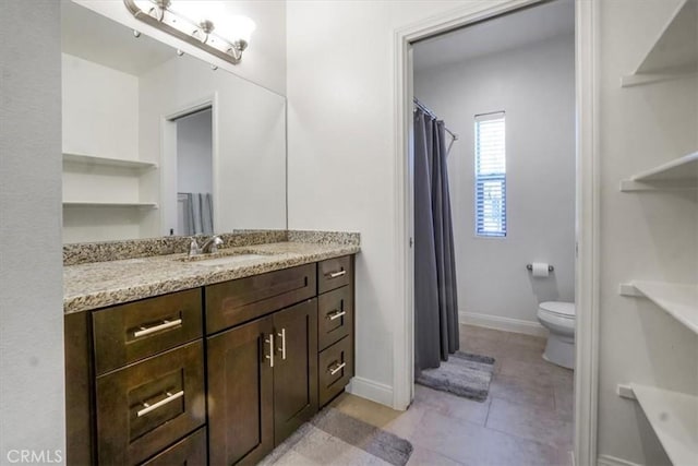 bathroom featuring toilet, tile patterned floors, and vanity