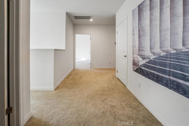 hallway with light colored carpet