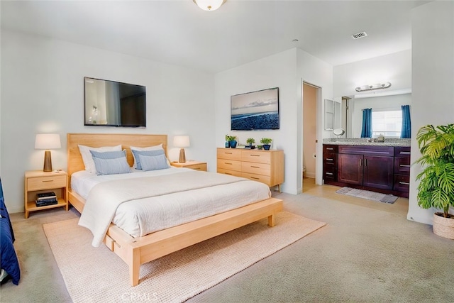 carpeted bedroom with sink