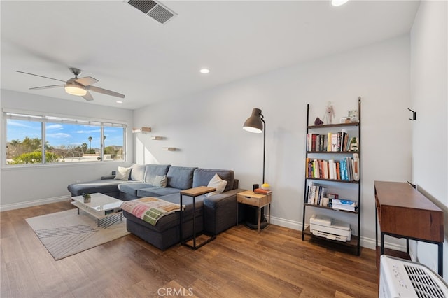 living room featuring ceiling fan and wood-type flooring