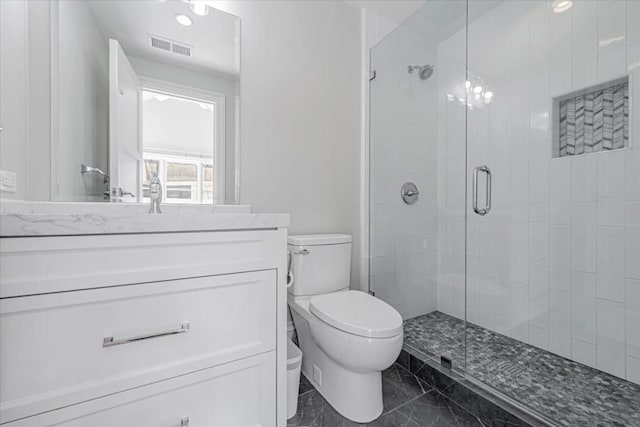 bathroom featuring an enclosed shower, vanity, and toilet