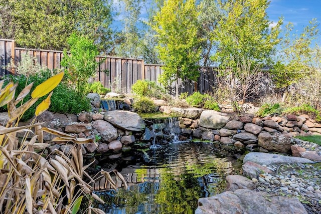 view of yard featuring a garden pond