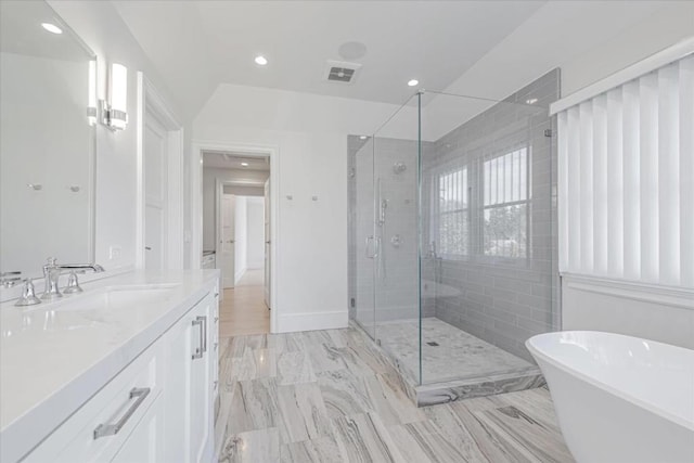 bathroom featuring independent shower and bath and vanity