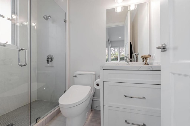 bathroom with hardwood / wood-style flooring, vanity, toilet, and an enclosed shower