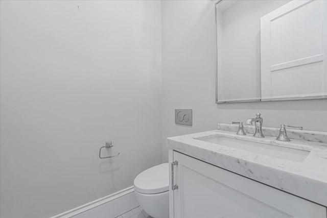 bathroom featuring vanity, tile patterned flooring, and toilet