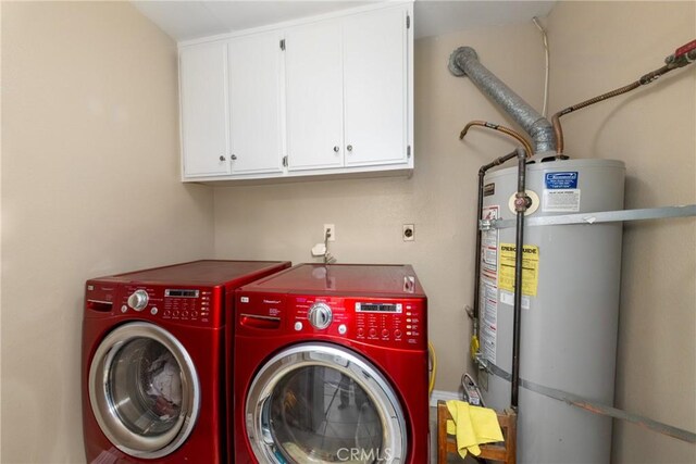 clothes washing area with cabinets, washing machine and clothes dryer, and strapped water heater