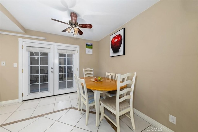 tiled dining space featuring french doors and ceiling fan