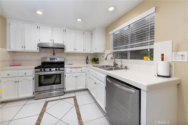 kitchen featuring white cabinetry, stainless steel appliances, sink, and tasteful backsplash