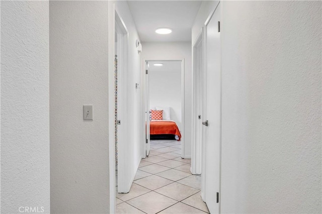 hallway with light tile patterned floors