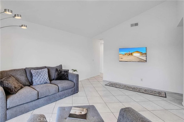 living room featuring vaulted ceiling and light tile patterned flooring