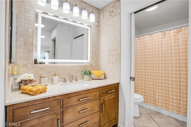 bathroom with toilet, vanity, walk in shower, tile patterned floors, and decorative backsplash