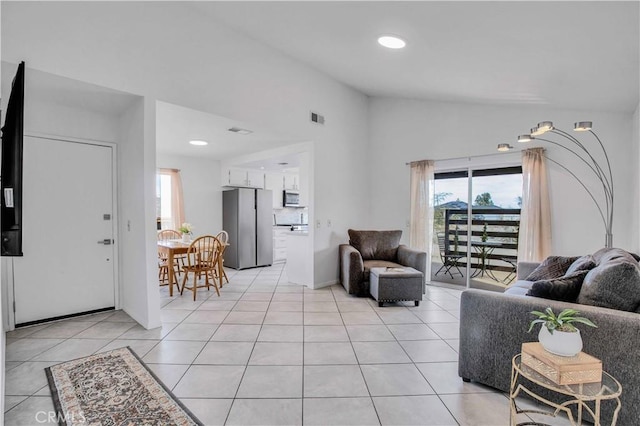 living room featuring light tile patterned floors and lofted ceiling