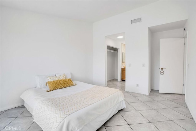 tiled bedroom with connected bathroom