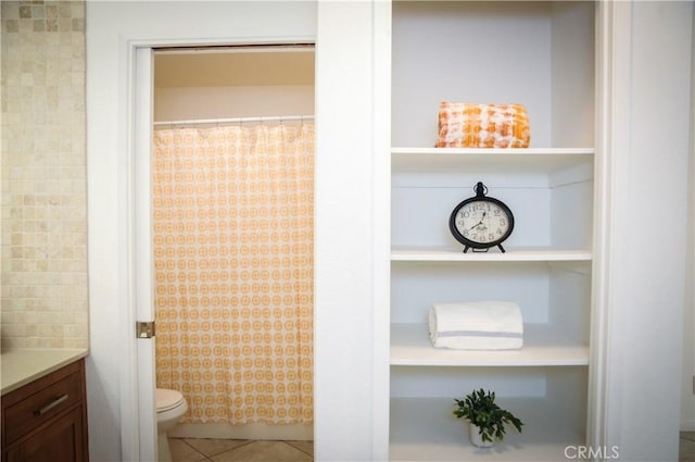 bathroom with toilet, tile patterned floors, a shower with curtain, and vanity