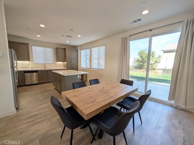 dining space featuring light hardwood / wood-style floors and sink