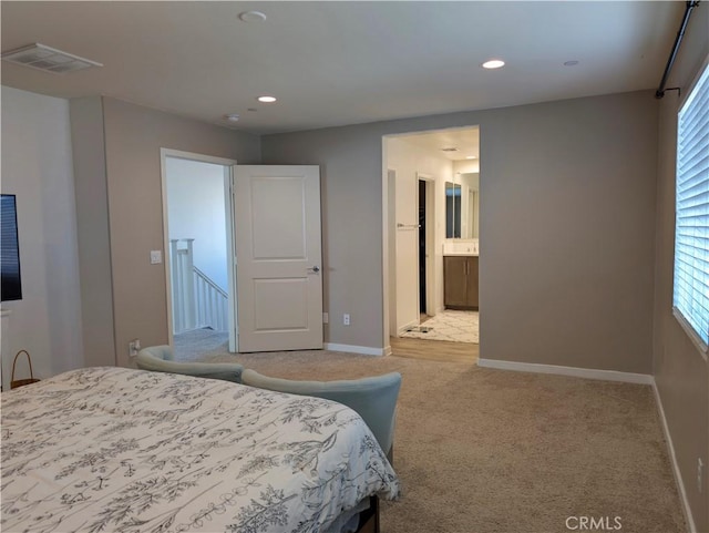 carpeted bedroom with ensuite bath