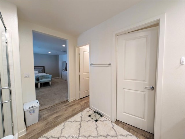 hallway with light hardwood / wood-style flooring