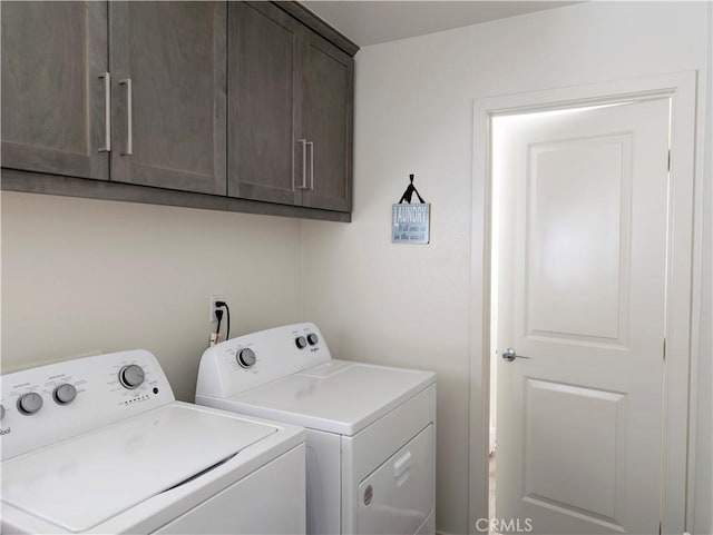 washroom featuring washer and dryer and cabinets