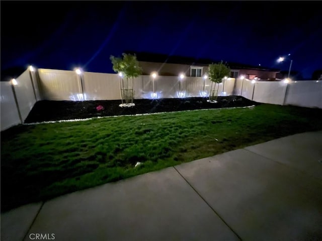 view of yard at twilight