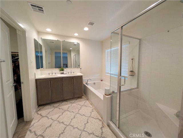 bathroom with independent shower and bath and vanity