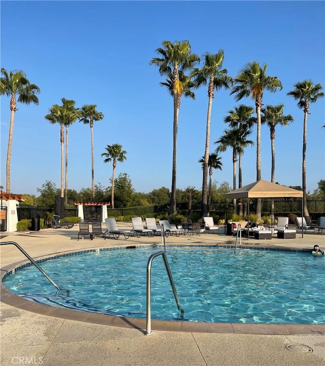 view of swimming pool featuring a gazebo and a patio area