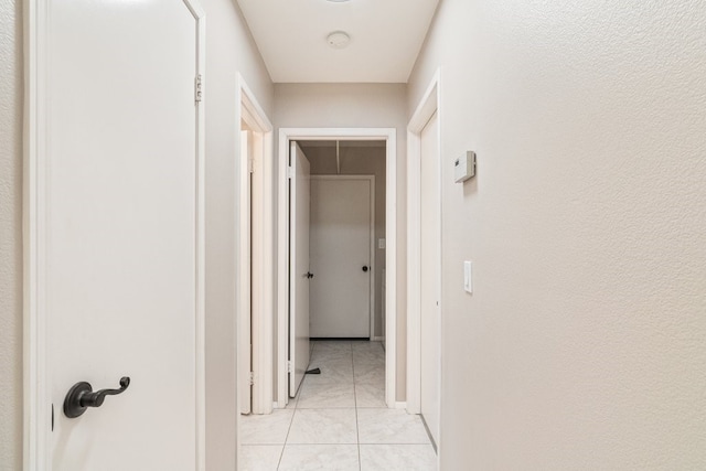 corridor with light tile patterned floors