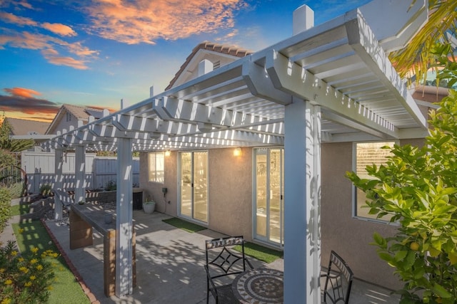 patio terrace at dusk with a pergola