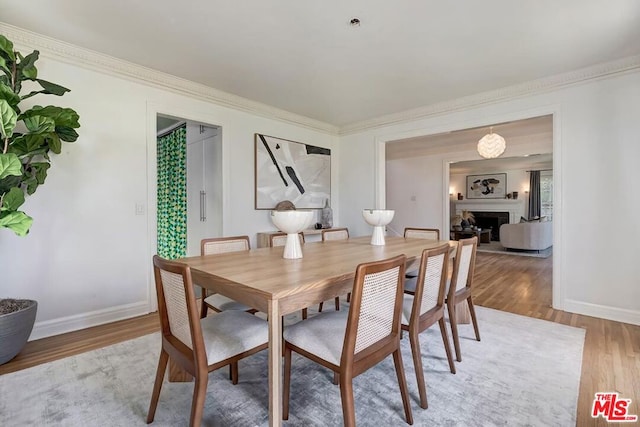 dining area featuring ornamental molding and hardwood / wood-style floors