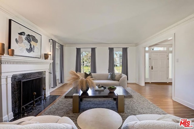 living room with dark wood-type flooring and crown molding