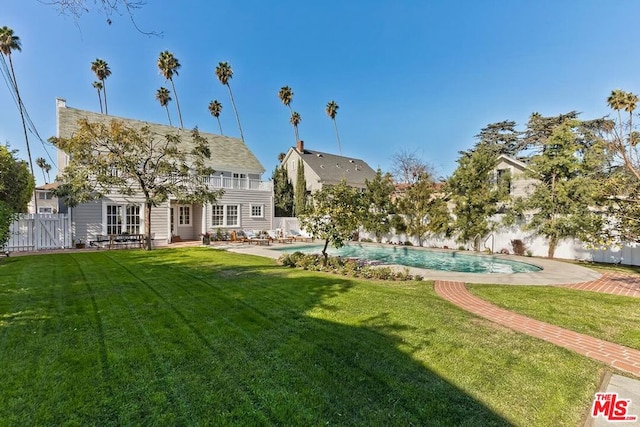 exterior space featuring a fenced in pool, a yard, french doors, and a patio