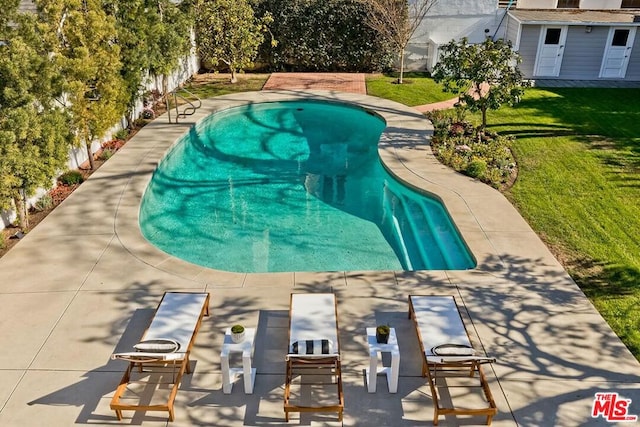 view of swimming pool with a diving board, a patio, and a yard