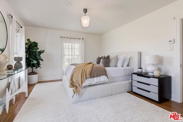 bedroom with dark wood-type flooring