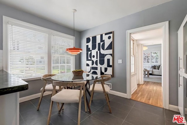 dining room with dark tile patterned flooring