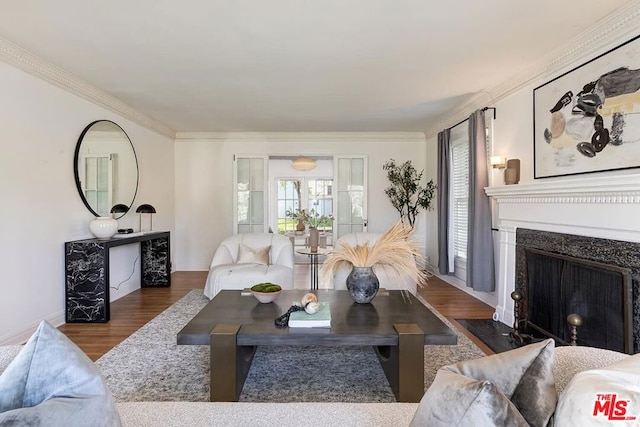 living room featuring dark hardwood / wood-style flooring, crown molding, and french doors