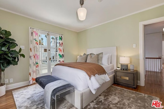 bedroom with dark wood-type flooring, access to exterior, and ornamental molding