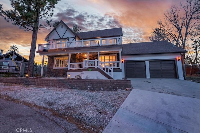 636 Talmadge Rd, Big Bear Lake, CA 92315 - view of front facade featuring an attached garage, covered porch, driveway, and a shingled roof