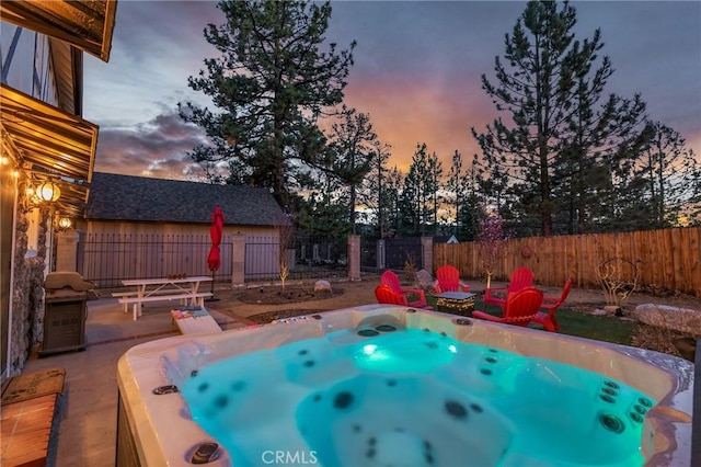 636 Talmadge Rd, Big Bear Lake, CA 92315 - pool at dusk with a patio area, a hot tub, and fence