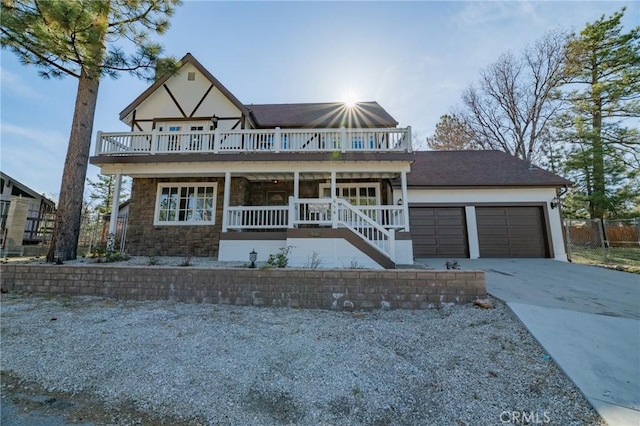 view of front facade featuring covered porch and a garage