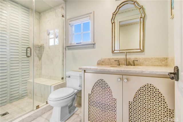 bathroom with toilet, vanity, and a shower with door