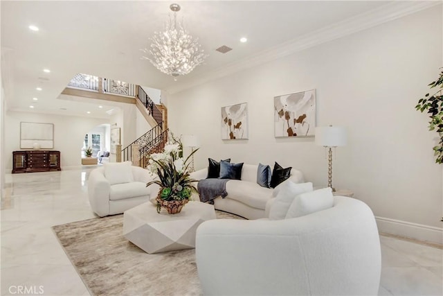 living room with crown molding and a chandelier